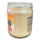 a close up of a jar of yogurt on a black background